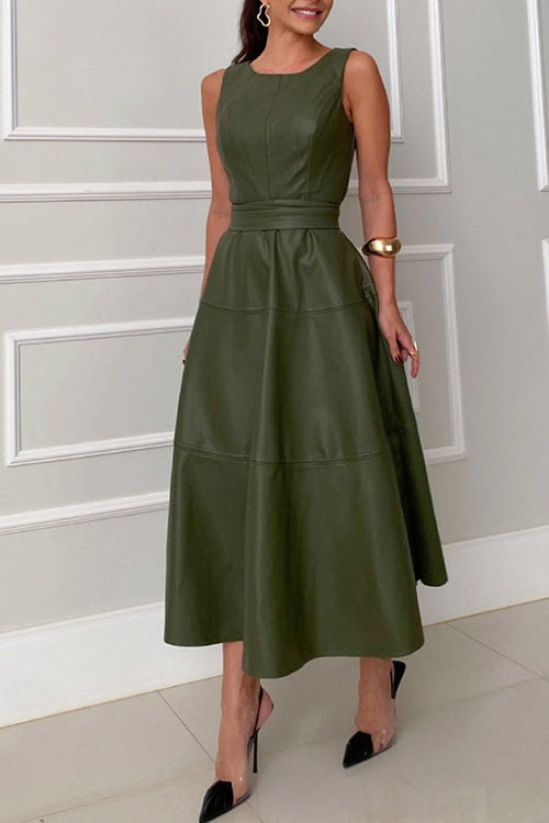 Woman wearing a sleeveless olive green faux leather midi dress with a belted waist and a flared skirt, side view