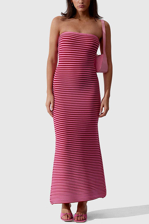 Model wearing a pink and red striped strapless maxi dress with a pink shoulder bag and pink heeled sandals