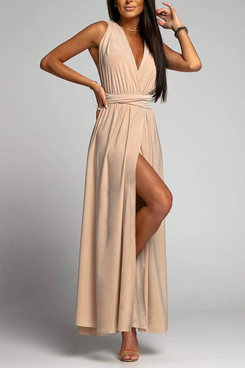 woman in a beige maxi dress with a high slit and deep v-neck