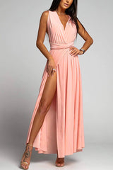 woman in a pink maxi dress with a high slit and deep v-neck