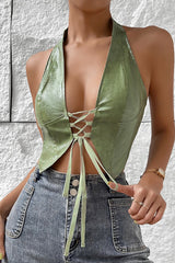 Woman wearing a green faux leather halter top with lace-up front