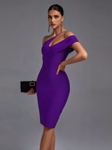 Woman in a purple one-shoulder dress holding a black clutch