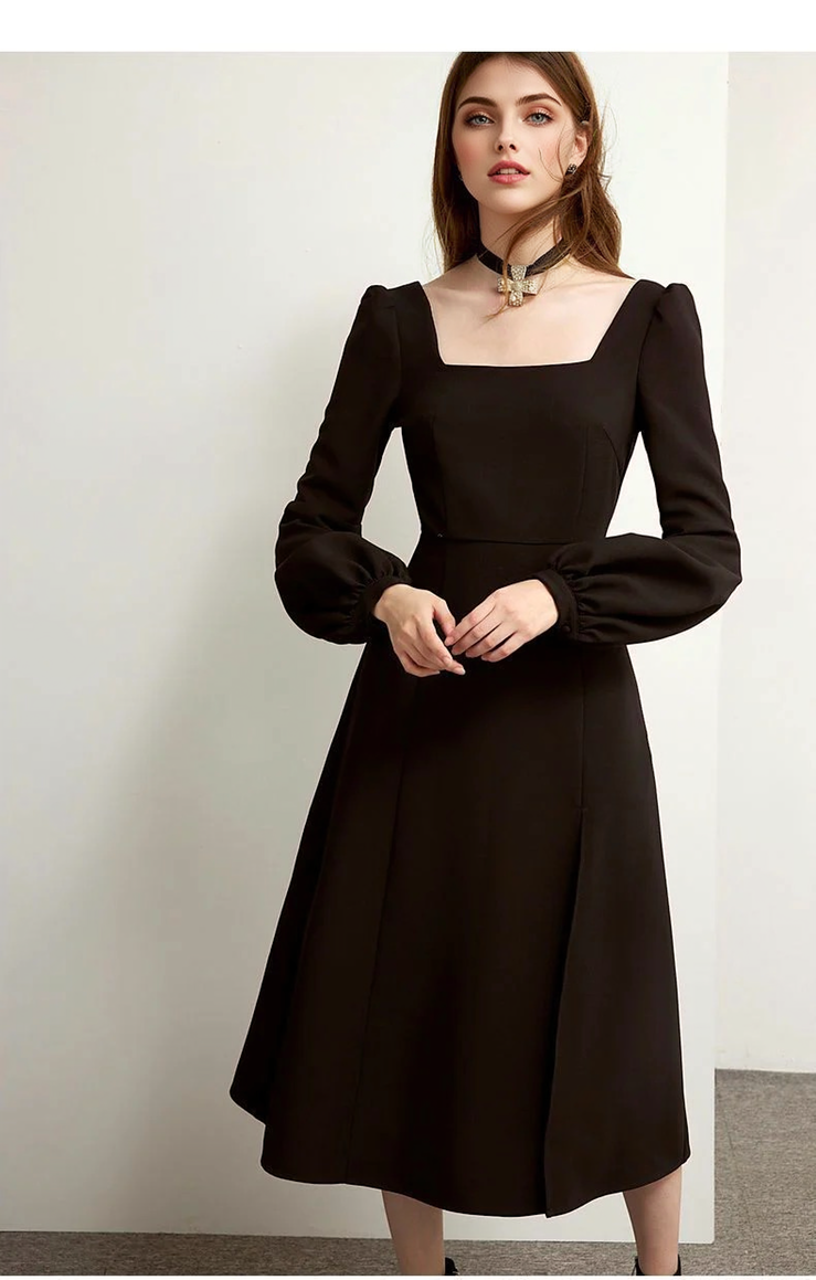 A woman wearing a black long-sleeved midi dress with a square neckline and puff sleeves.