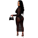 back view of a woman in a sheer black long-sleeved dress with a plunging neckline and a high slit, holding a black clutch bag and wearing black strappy heels, on a white background