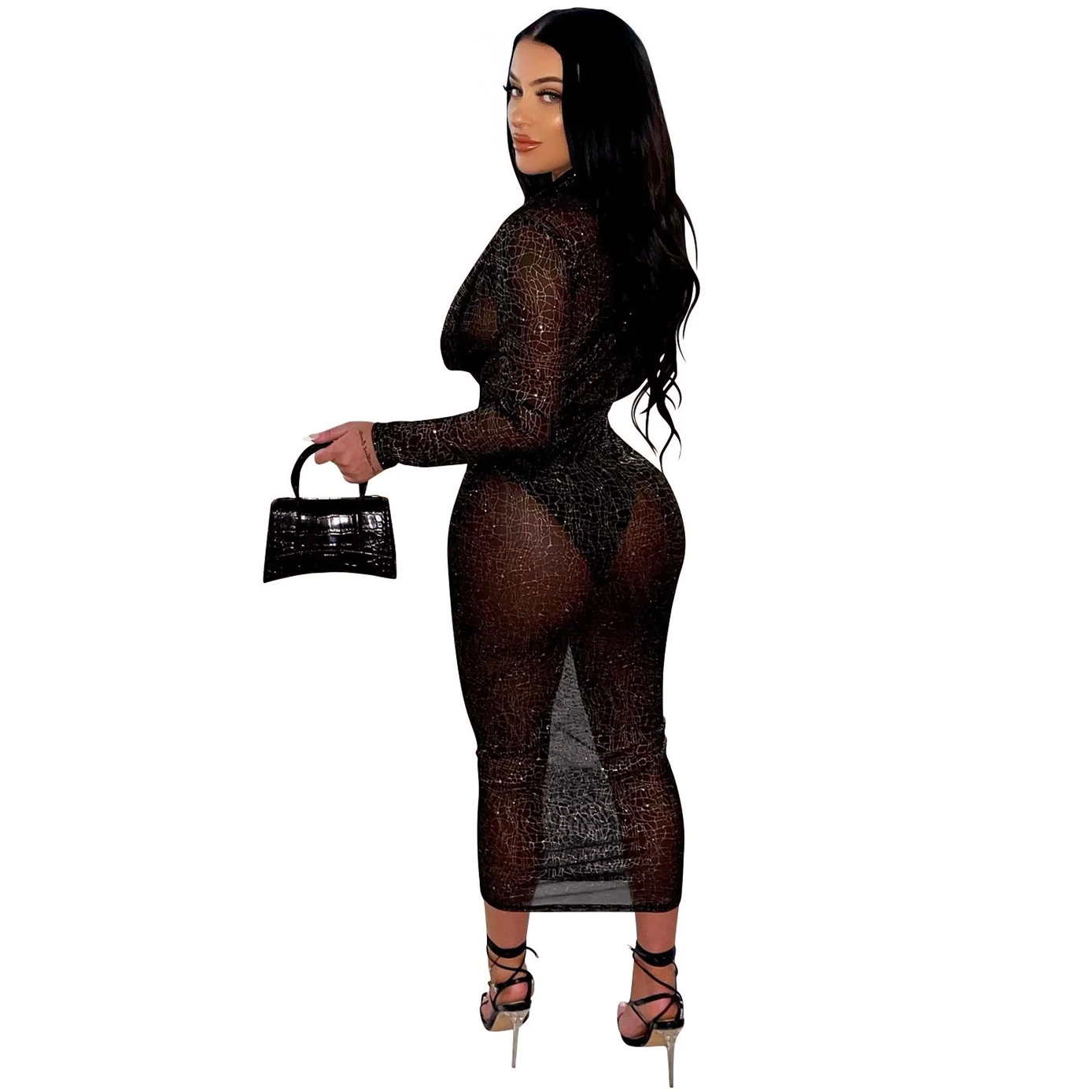 back view of a woman in a sheer black long-sleeved dress with a plunging neckline and a high slit, holding a black clutch bag and wearing black strappy heels, on a white background