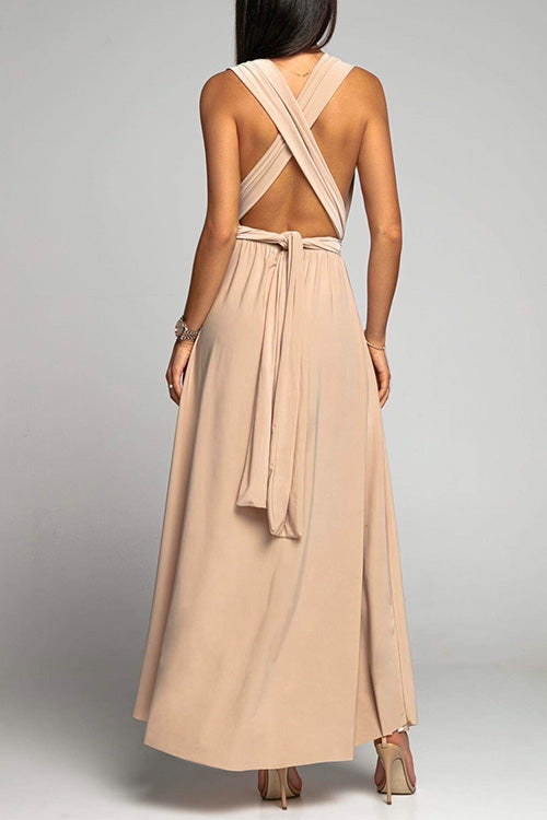 back view of a beige maxi dress with a halter neck and tie detail