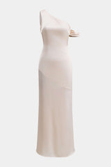 A cream one-shoulder satin maxi dress with an asymmetrical neckline and a diagonal seam across the skirt.
