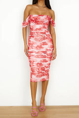 woman in a pink and red floral print off-the-shoulder ruched midi dress and pink strappy heels