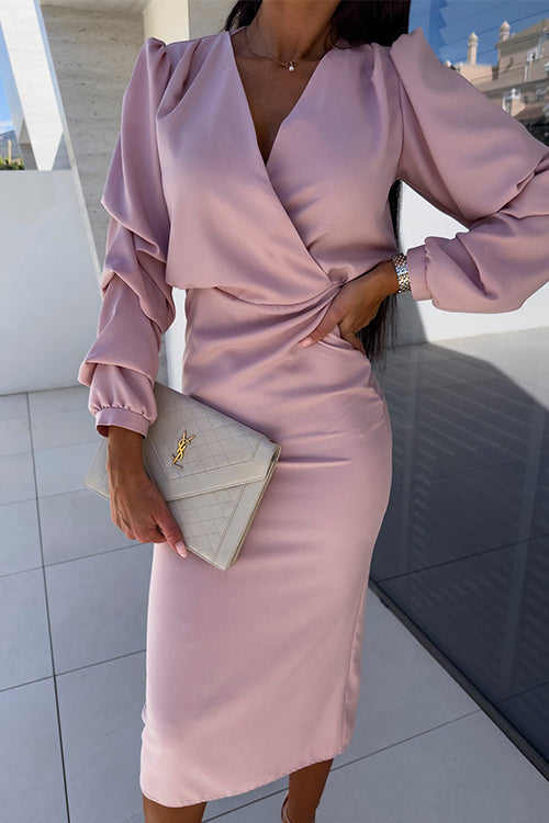 woman in pink v-neck faux wrap long sleeve dress with pencil skirt holding a clutch