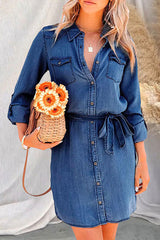 Woman wearing a dark denim shirt dress with a basket purse