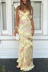 Woman wearing a yellow floral print maxi dress with ruffles