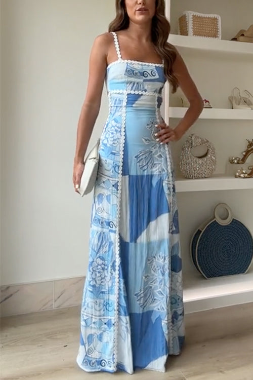 Woman posing in a blue and white patchwork maxi dress with lace trim and spaghetti straps.