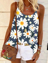 Woman wearing a navy blue tank top with a white daisy print, white shorts, and a woven crossbody bag.
