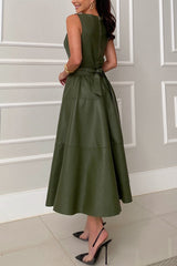 Woman wearing a sleeveless olive green faux leather midi dress with a belted waist and a flared skirt, back view