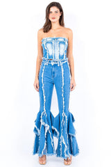 woman wearing a blue denim strapless top and bell-bottom jeans with frayed detailing