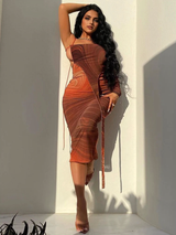 A woman with long dark hair posing in a brown and orange abstract print one-shoulder midi dress.