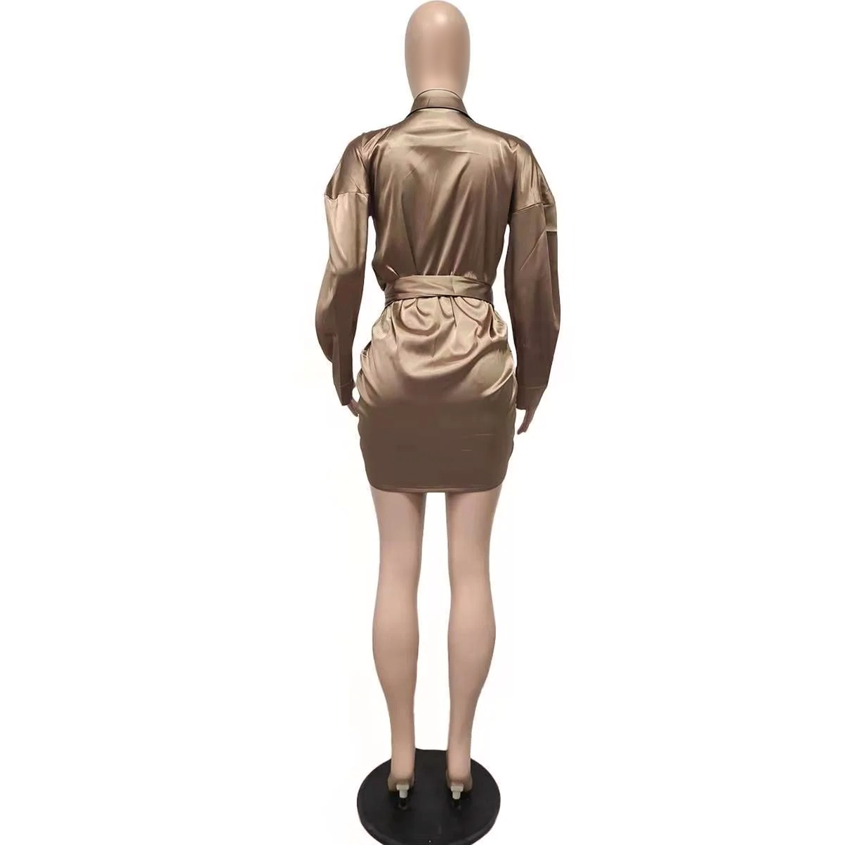 Back view of a mannequin wearing a bronze satin mini dress with long sleeves and a tie waist.