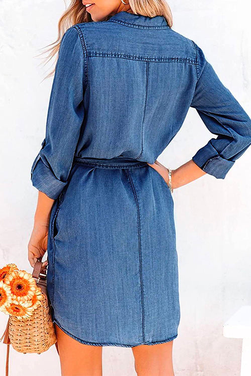 Woman wearing a dark denim shirt dress from the back