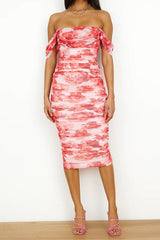 woman in a pink and red floral print off-the-shoulder ruched midi dress and pink strappy heels