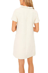 Back view of a cream-colored tweed shift dress with short sleeves.
