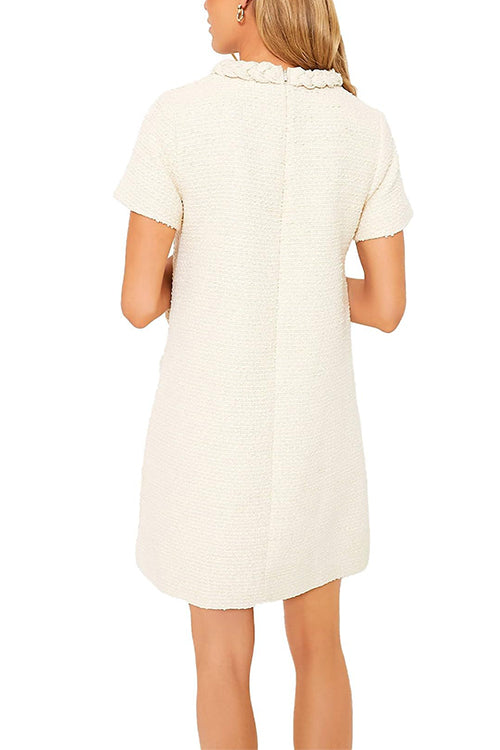 Back view of a cream-colored tweed shift dress with short sleeves.