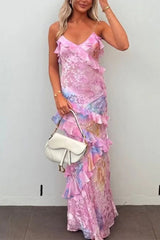 Woman wearing a pink and blue tie-dye maxi dress with ruffles