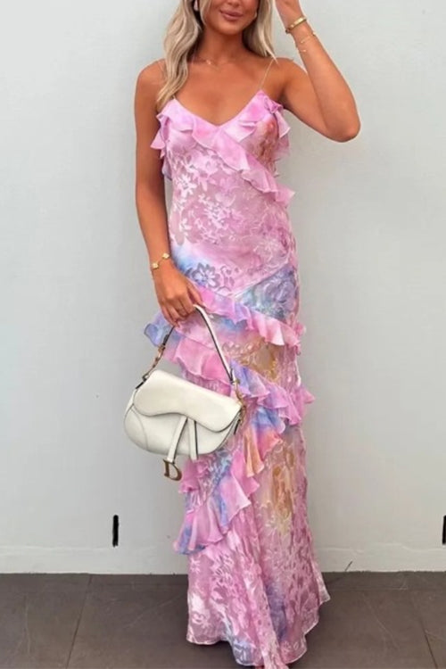 Woman wearing a pink and blue tie-dye maxi dress with ruffles
