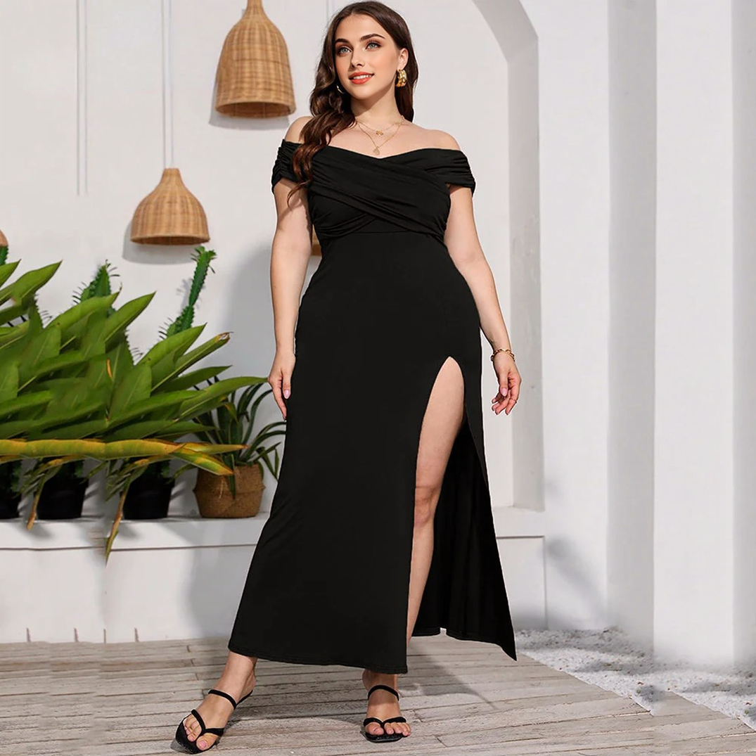 A woman in a black off-the-shoulder maxi dress with a high slit.