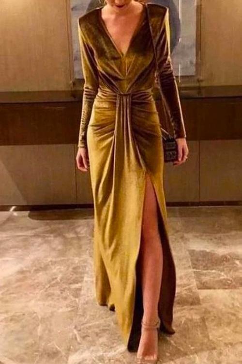 woman in a gold velvet dress with a high slit