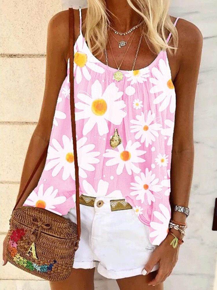 Woman wearing a pink tank top with a white daisy print, white shorts, and a woven crossbody bag.