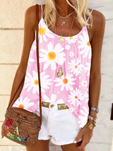 Woman wearing a pink tank top with a white daisy print, white shorts, and a woven crossbody bag.