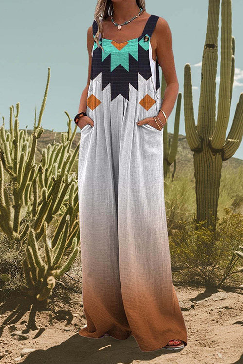Woman wearing a white jumpsuit with a geometric print and ombre effect, standing in a desert landscape with cacti.