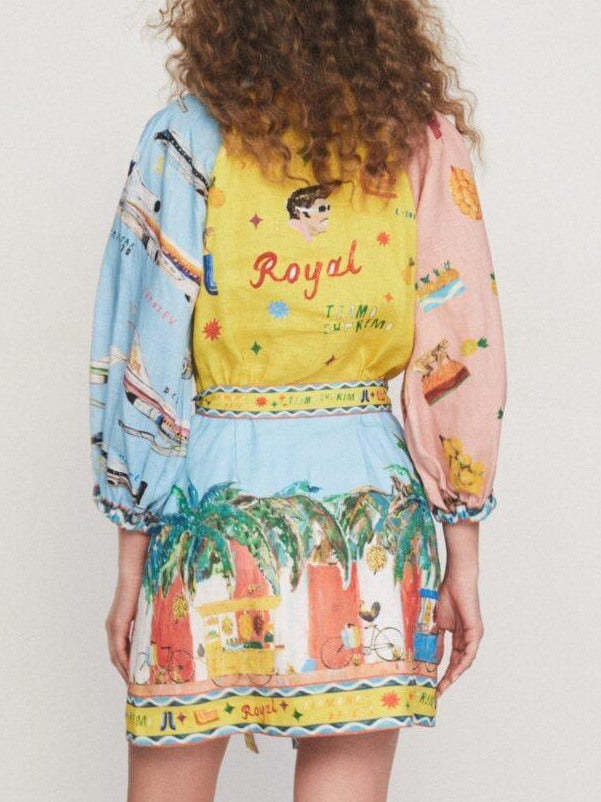 Back view of a woman in a colorful printed shirt dress with patchwork design.