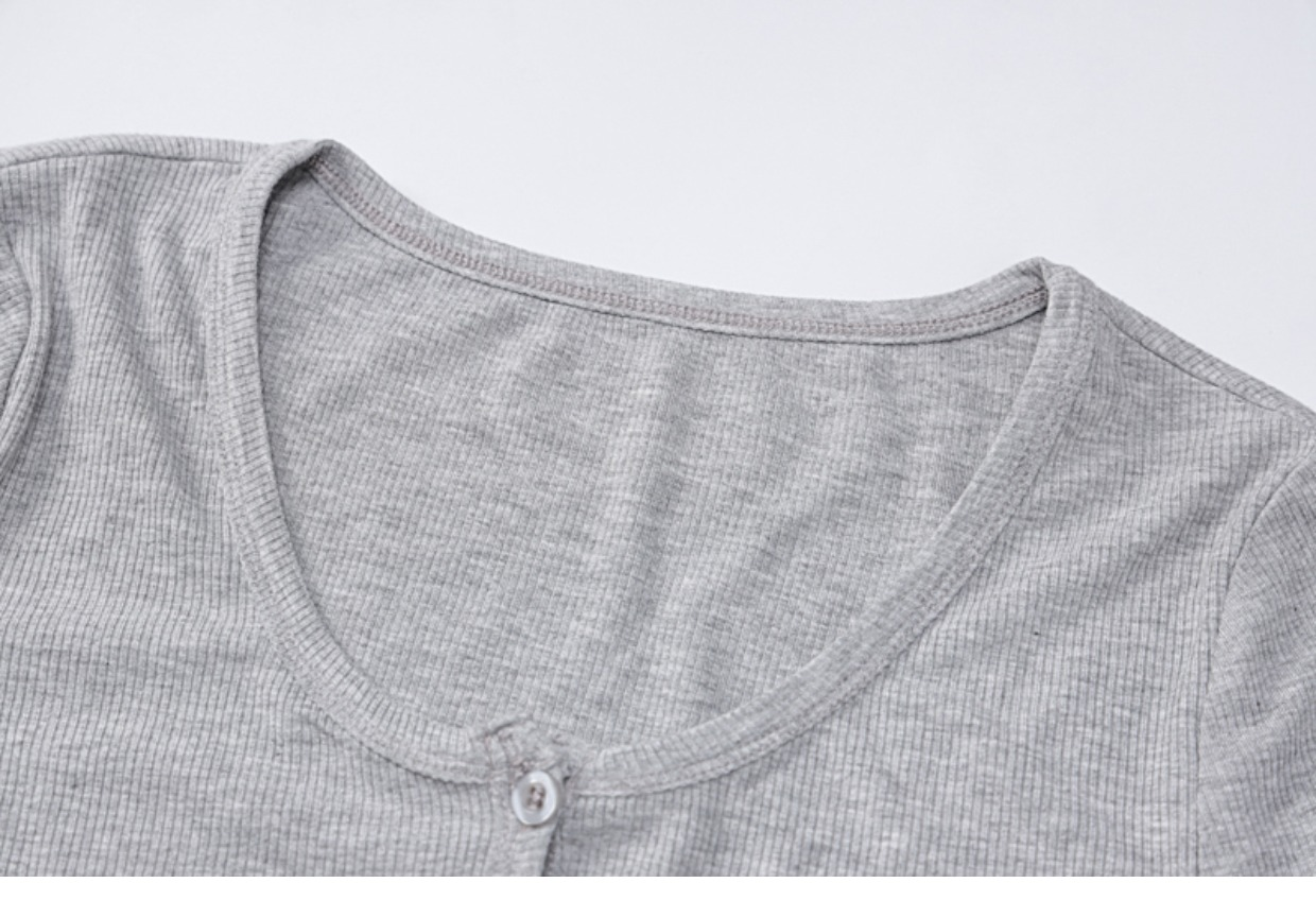 Close-up of the neckline of a grey ribbed long-sleeve crop top
