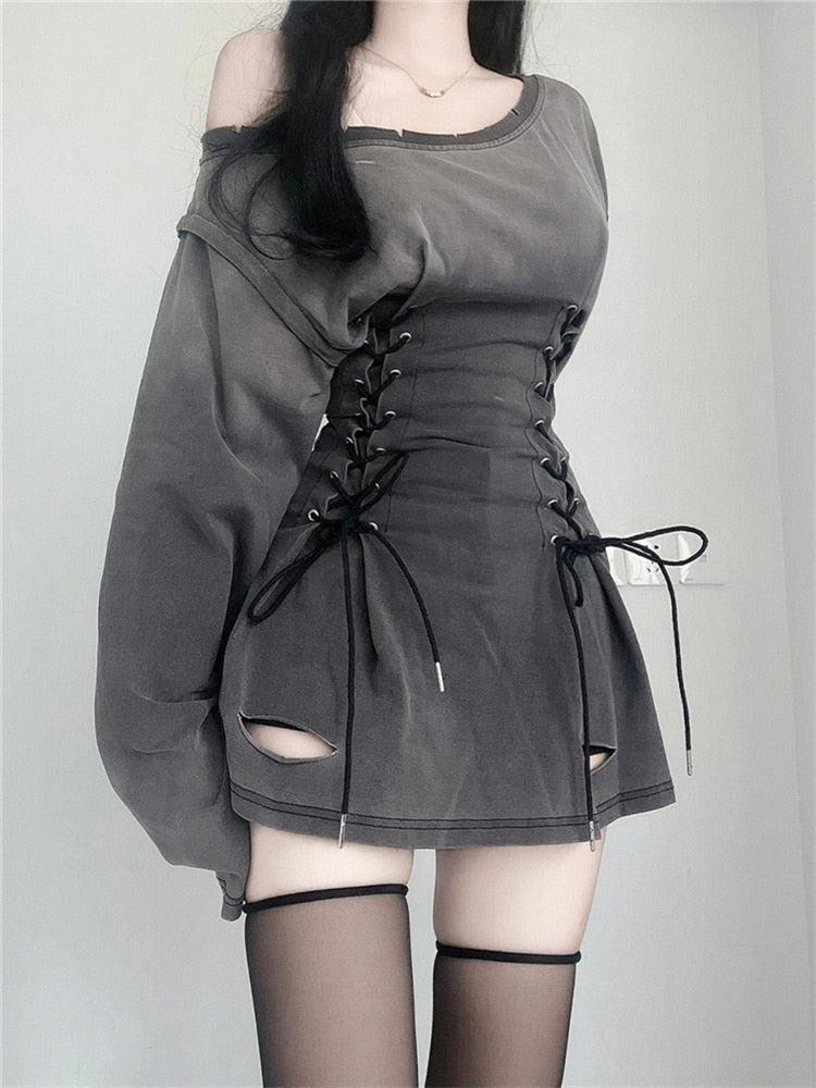Close-up of the gray dress showing the lace-up corset waist and cut-out details.