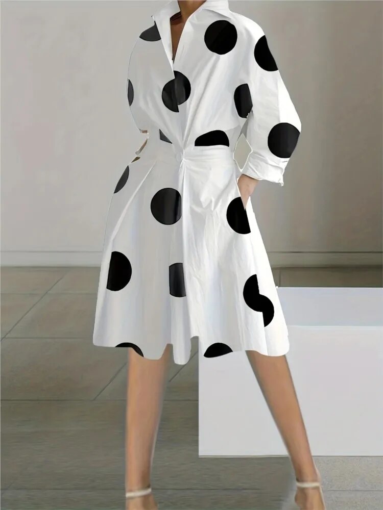 A woman wearing a white polka dot shirt dress