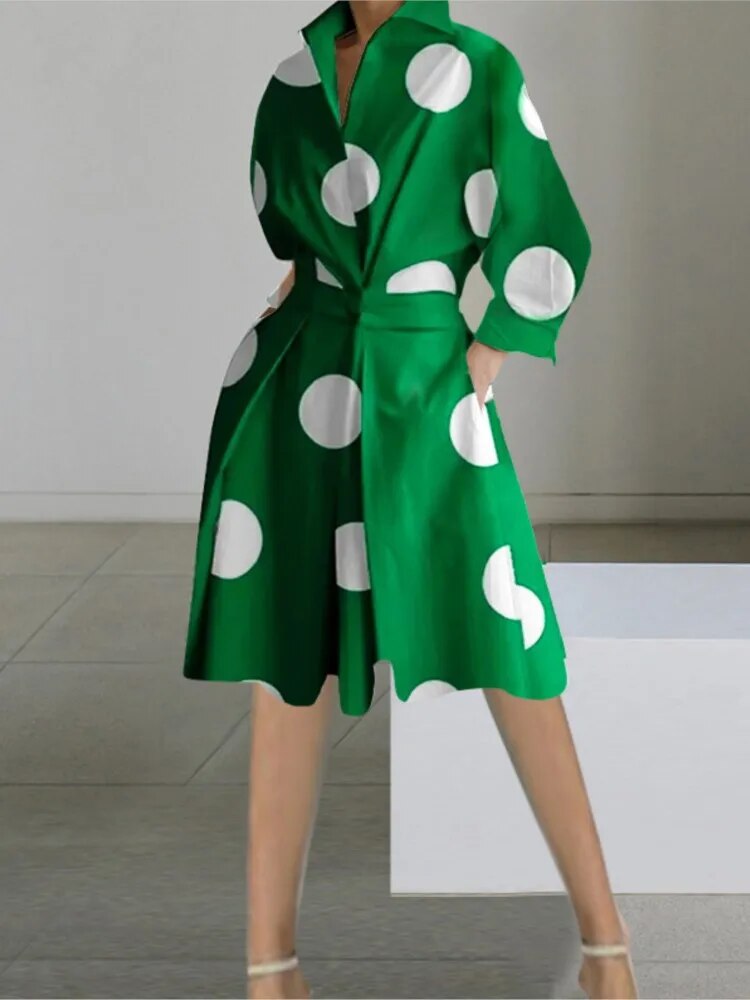 A woman wearing a green polka dot shirt dress