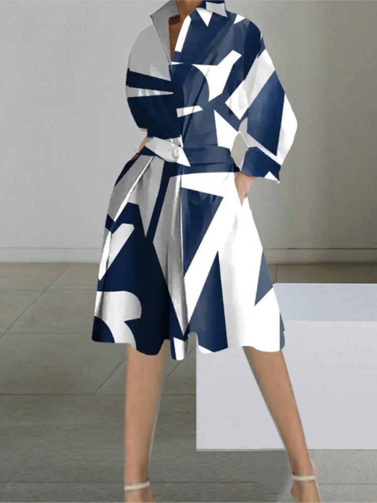 A woman wearing a navy and white geometric print shirt dress