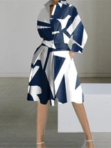 A woman wearing a navy and white geometric print shirt dress