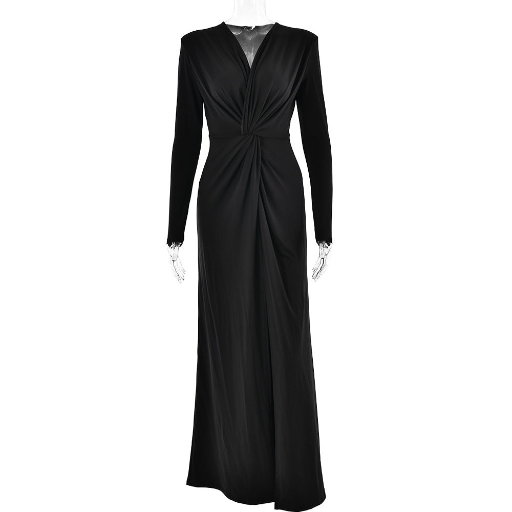 Black long-sleeved maxi dress with a plunging neckline and a high slit.