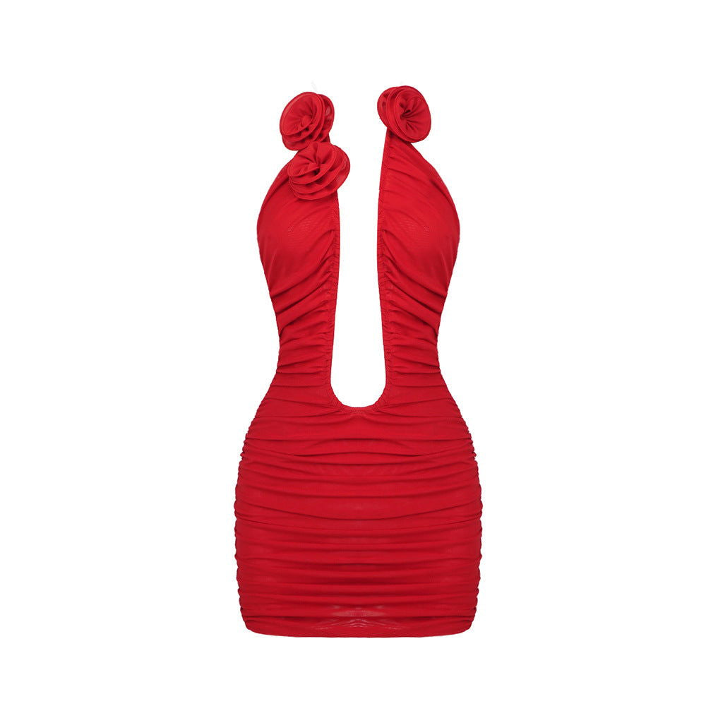 A red ruched mini dress with a plunging neckline and floral embellishments at the shoulders, shown on a white background.
