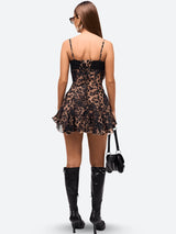 Back view of a woman in a leopard print mini dress with lace detail