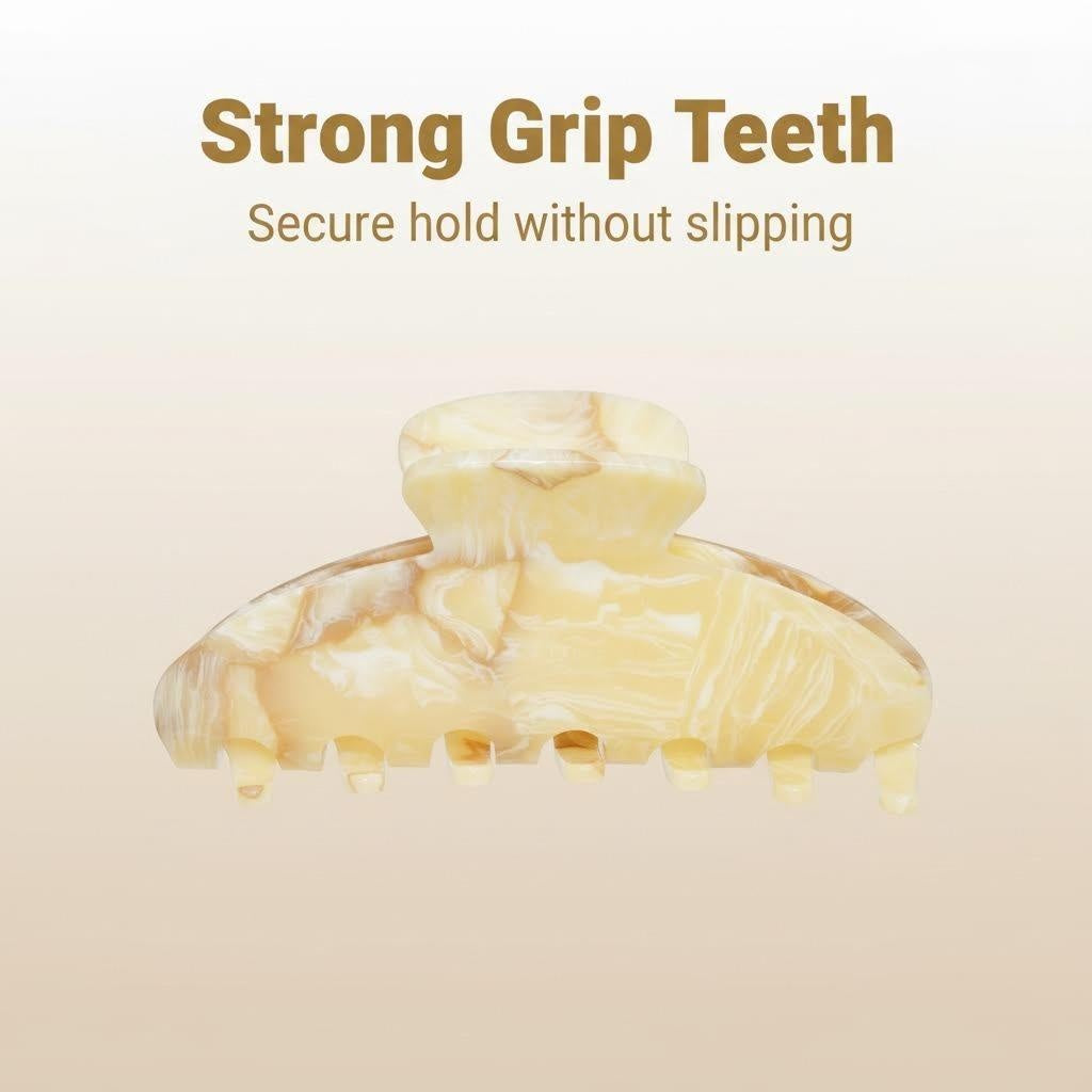 A claw hair clip with a marble pattern is displayed with text highlighting its strong grip teeth for a secure hold.