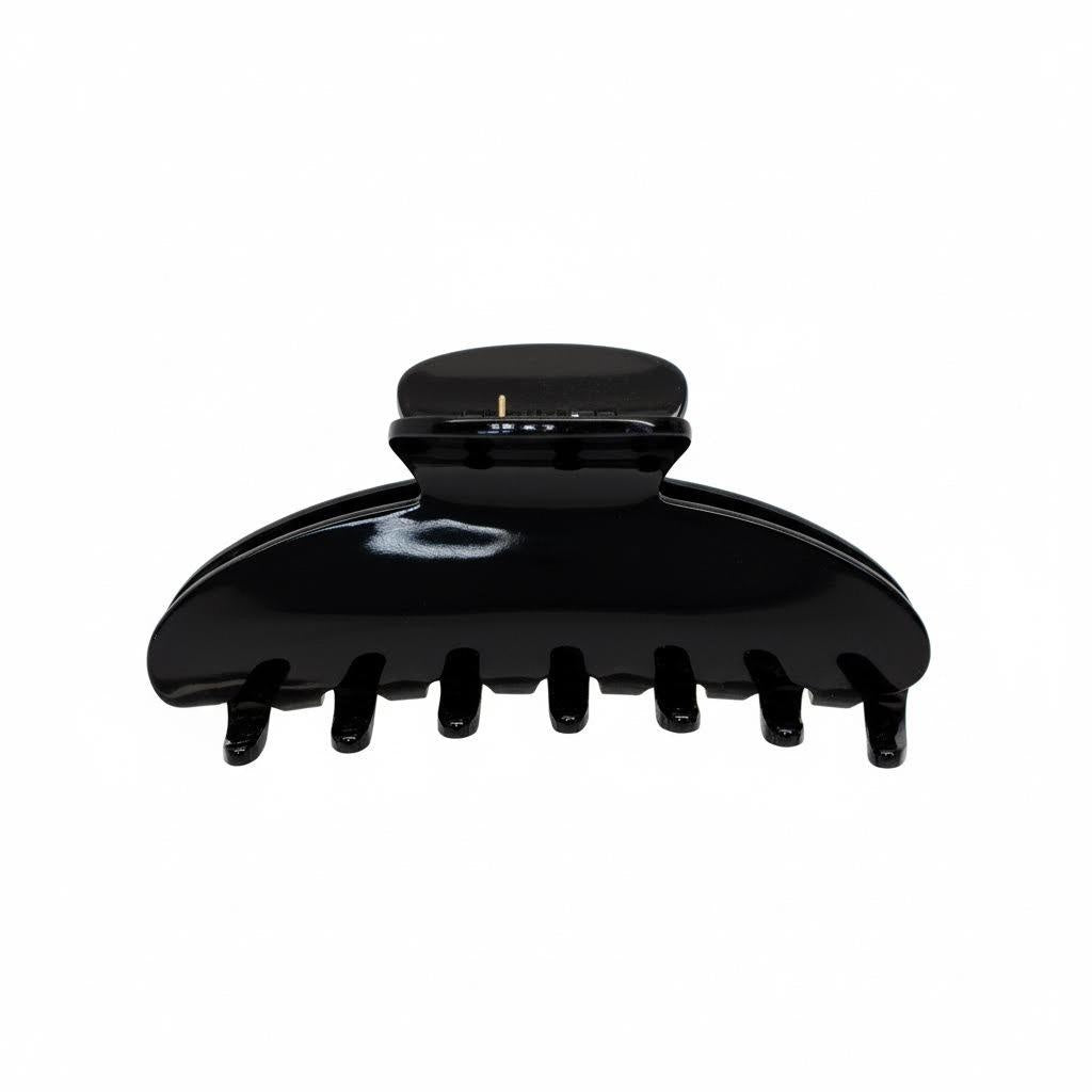 A black claw hair clip is shown against a white background.