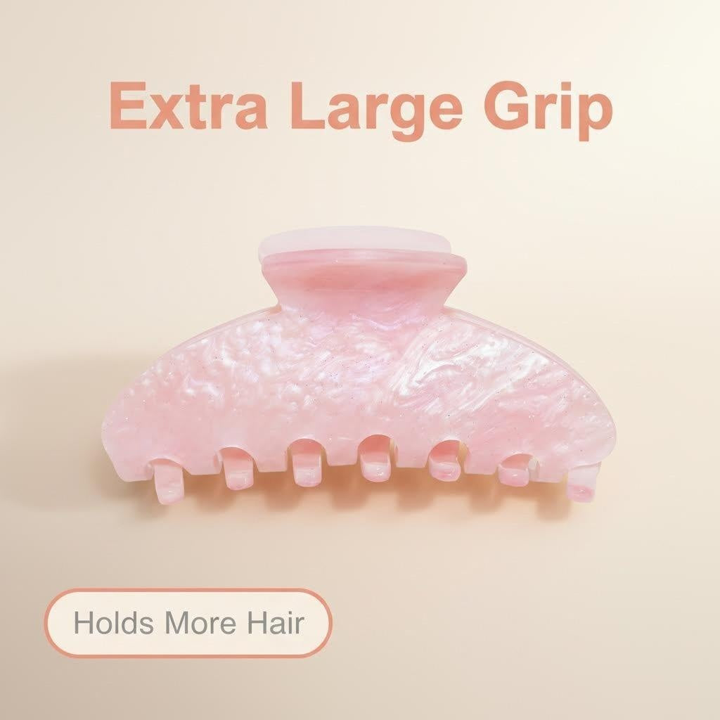 A pink pearlescent claw clip with text overlay indicating 'Extra Large Grip' and 'Holds More Hair'.