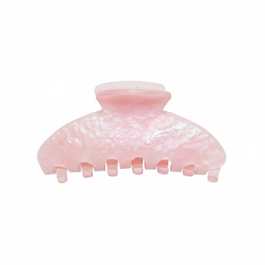 A pink pearlescent claw clip on a white background.