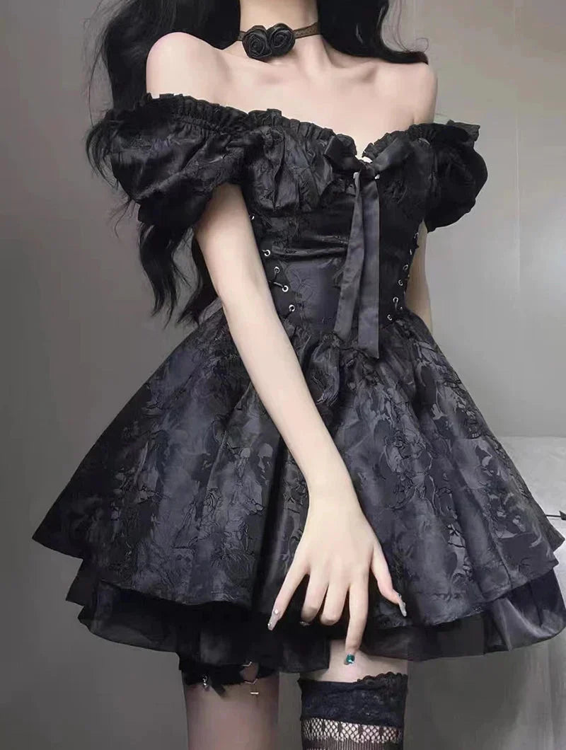 Woman wearing a short black off-the-shoulder dress with puff sleeves and a tiered skirt.