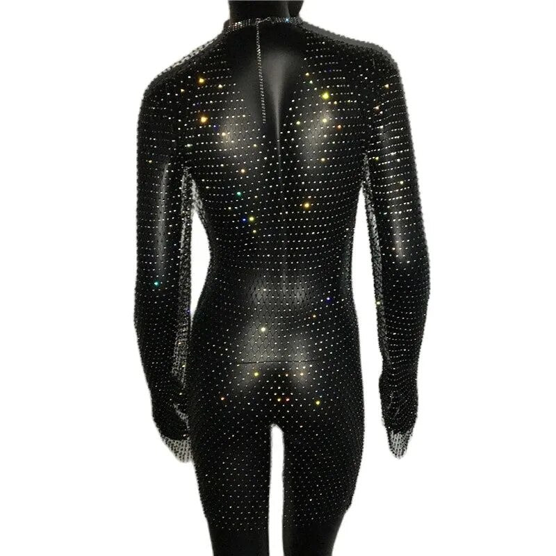 The back of a black full-body jumpsuit covered in colorful rhinestones, with long sleeves and a high neckline.