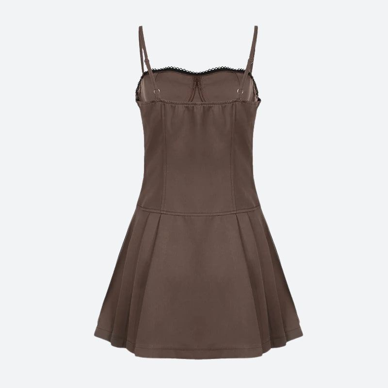 The back of a brown spaghetti strap dress with a black bow and lace trim, shown flat.