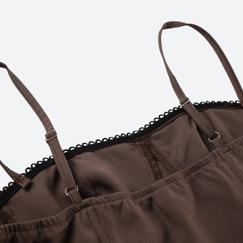 Close-up of the spaghetti straps and lace trim of a brown dress.